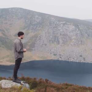 man standing by a mountain